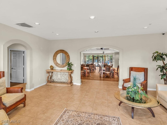 sitting room featuring light tile patterned flooring and ceiling fan