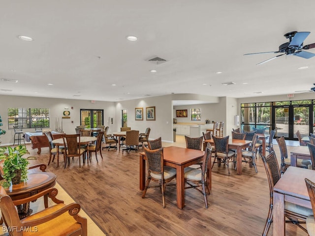 dining room with a wealth of natural light, french doors, light hardwood / wood-style flooring, and ceiling fan