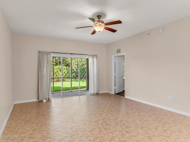 spare room with ceiling fan and light tile patterned flooring