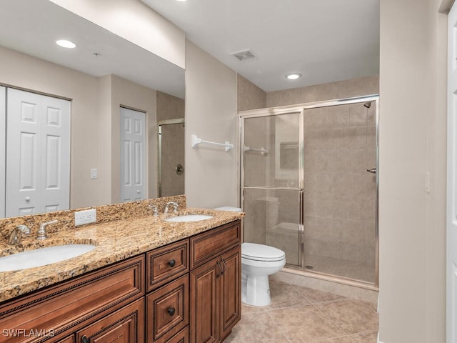 bathroom featuring vanity, tile patterned floors, toilet, and an enclosed shower