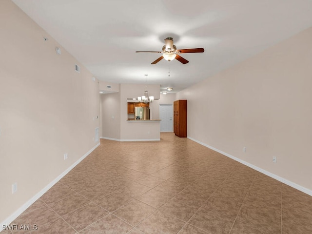 unfurnished living room featuring ceiling fan with notable chandelier