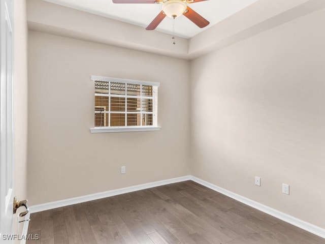 empty room with dark hardwood / wood-style floors and ceiling fan