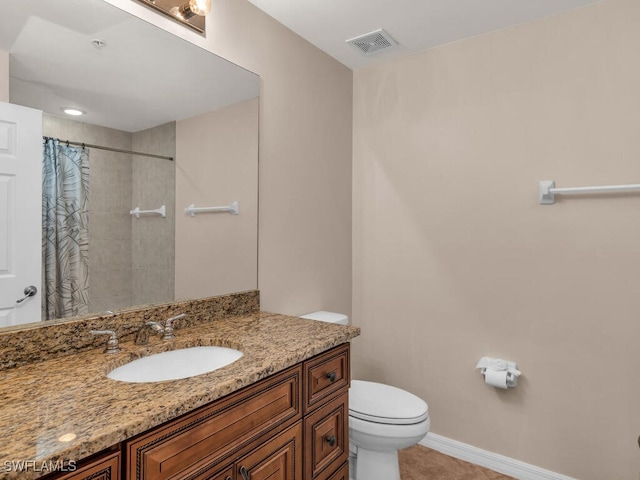 bathroom featuring toilet, a shower with curtain, vanity, and tile patterned floors