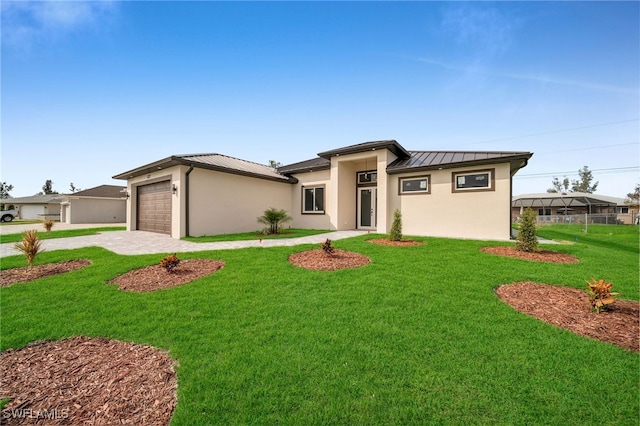 prairie-style home with a garage and a front lawn