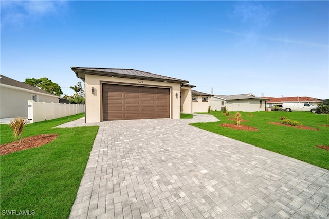 view of front of home with a front lawn and a garage