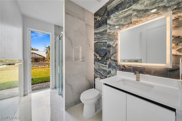 bathroom with vanity, toilet, tile walls, and a shower with shower curtain