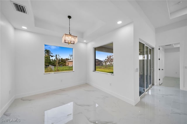 unfurnished dining area featuring a chandelier and a wealth of natural light