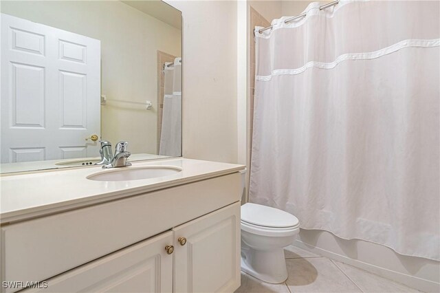 full bathroom with tile patterned flooring, vanity, shower / tub combo, and toilet