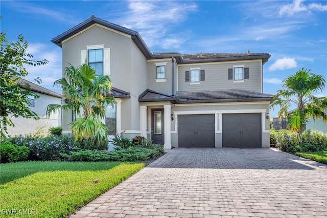 view of front of home featuring a front lawn and a garage