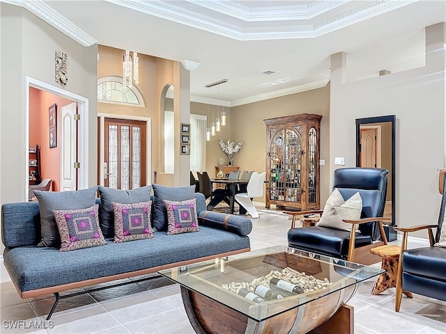living room with light tile patterned floors, visible vents, arched walkways, and ornamental molding
