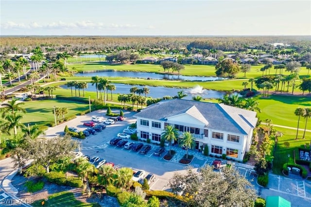 birds eye view of property with a water view and golf course view