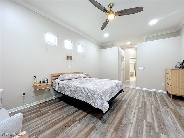 bedroom featuring hardwood / wood-style flooring, ceiling fan, and crown molding