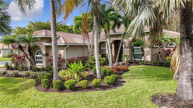 mediterranean / spanish-style home featuring a front lawn