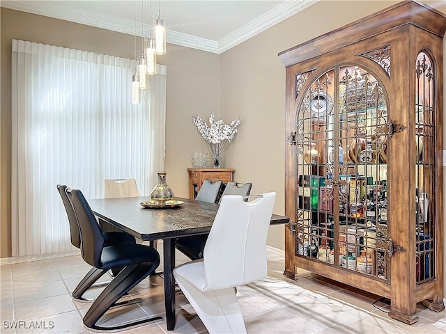 dining space featuring light tile patterned flooring, baseboards, and ornamental molding