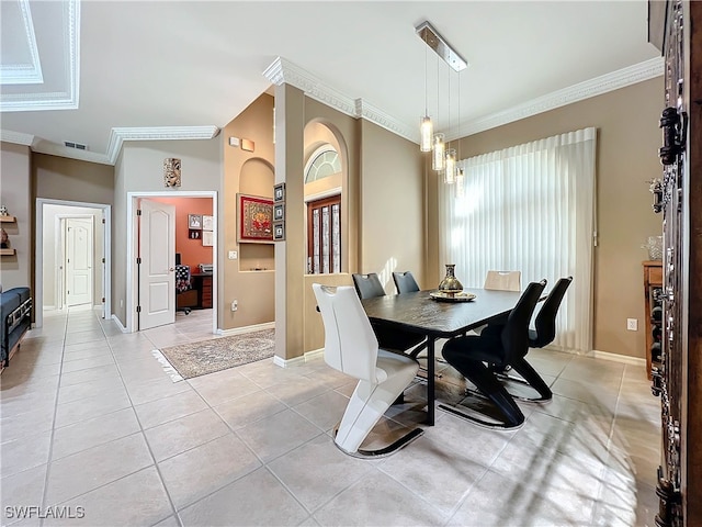 dining room with light tile patterned floors, baseboards, visible vents, and ornamental molding
