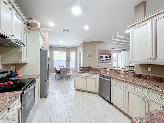 kitchen featuring visible vents, ornamental molding, light tile patterned floors, stainless steel appliances, and a sink
