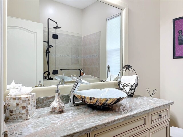 full bath featuring a walk in shower and vanity
