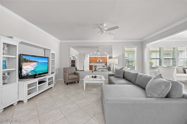 living room featuring ornamental molding, light tile patterned floors, and ceiling fan