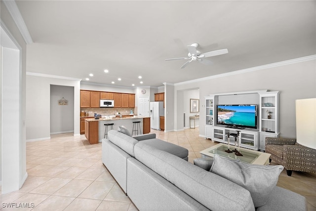 tiled living room with crown molding and ceiling fan