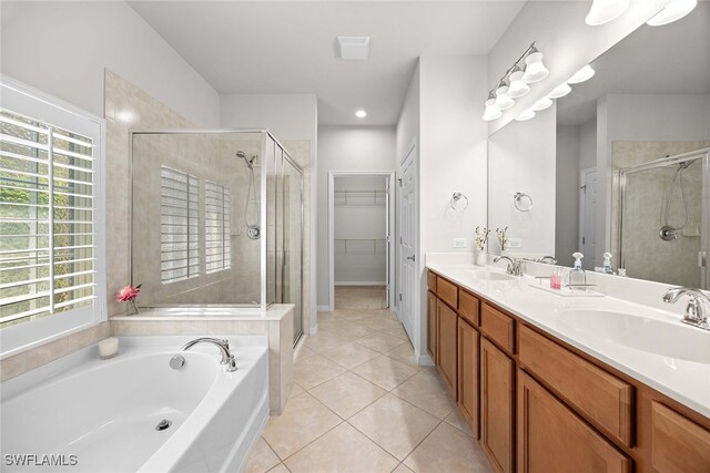 bathroom featuring vanity, independent shower and bath, and tile patterned flooring