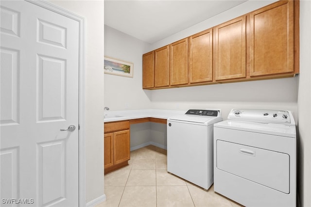 washroom with cabinets, independent washer and dryer, and light tile patterned flooring