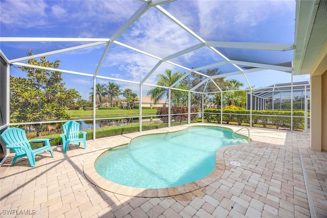 view of pool with a water view, a patio area, and a lanai