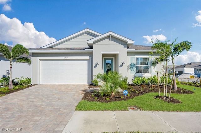 view of front of house with a front lawn and a garage