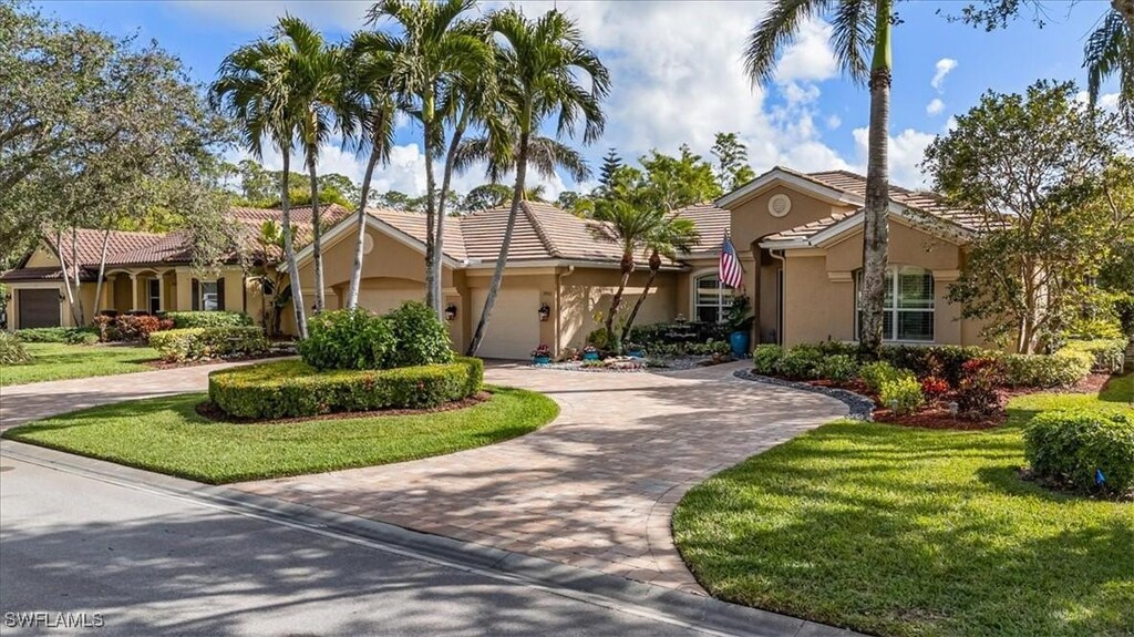 mediterranean / spanish house featuring a front lawn