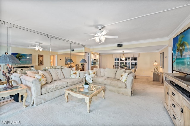 living room with crown molding, light colored carpet, and ceiling fan with notable chandelier