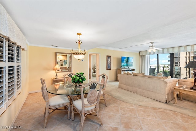 tiled dining space featuring crown molding and ceiling fan