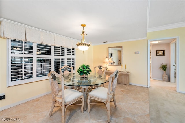 dining room featuring crown molding and light tile patterned flooring