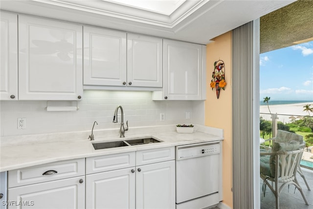 kitchen featuring white cabinetry, a water view, white dishwasher, and sink