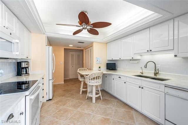 kitchen with white cabinets, sink, and white appliances