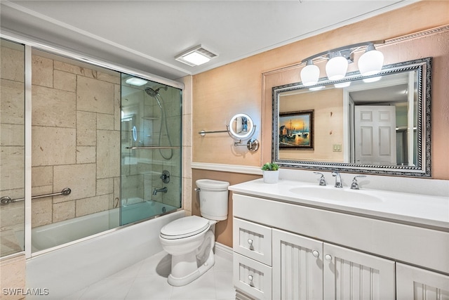 full bathroom featuring vanity, combined bath / shower with glass door, toilet, and tile patterned floors