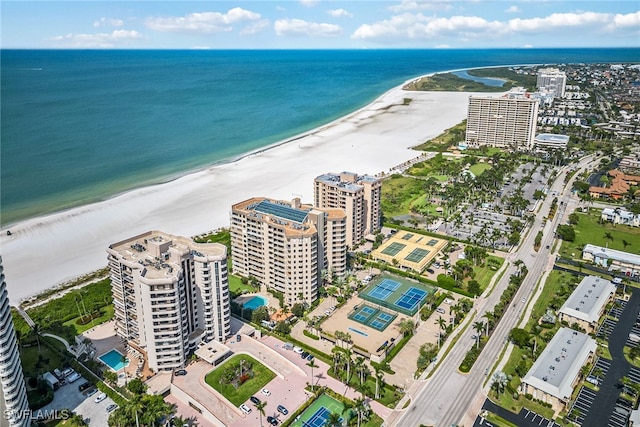 drone / aerial view featuring a water view and a beach view