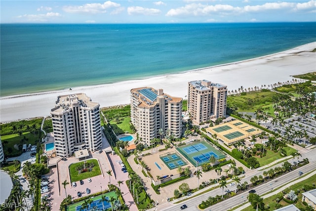 bird's eye view with a water view and a beach view