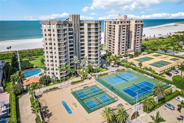 bird's eye view featuring a water view and a beach view