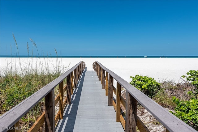 dock area featuring a view of the beach and a water view