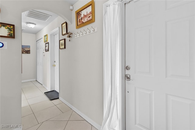 hall featuring light tile patterned flooring