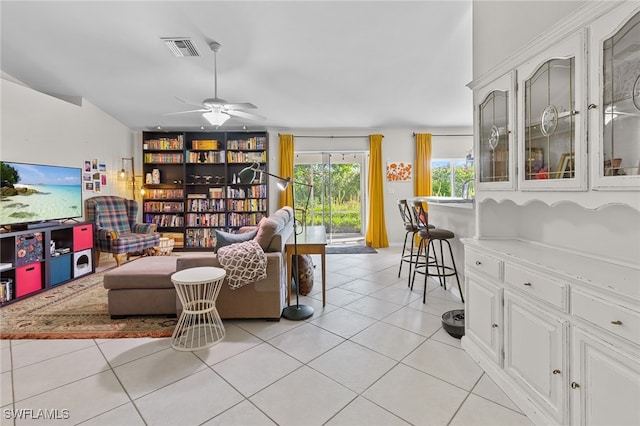 living room with ceiling fan and light tile patterned floors