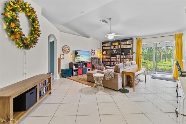 living room featuring ceiling fan, lofted ceiling, and light tile patterned floors