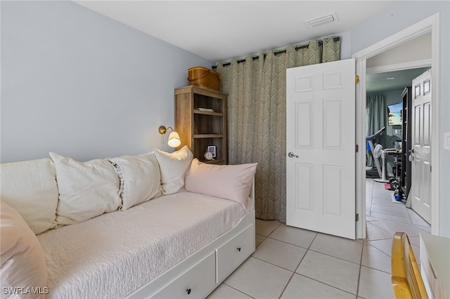 bedroom featuring light tile patterned floors