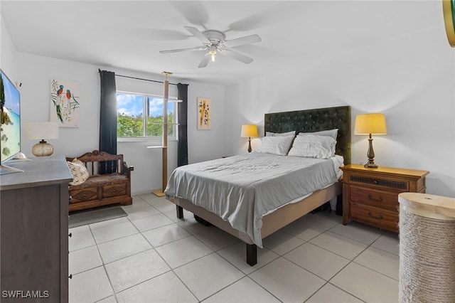 tiled bedroom featuring ceiling fan