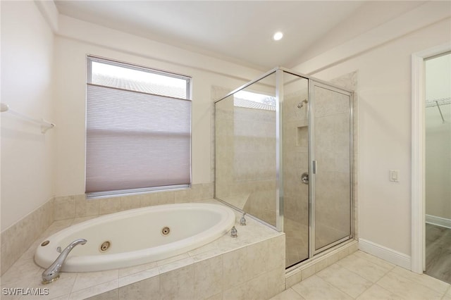 bathroom featuring tile patterned flooring and shower with separate bathtub