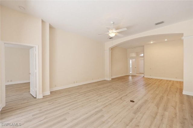 spare room with light wood-type flooring and ceiling fan