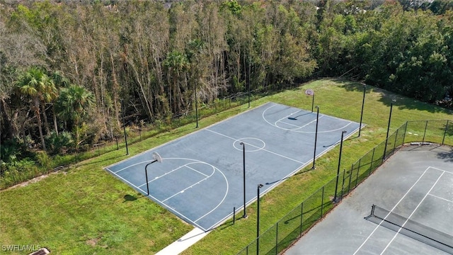 view of basketball court with a lawn