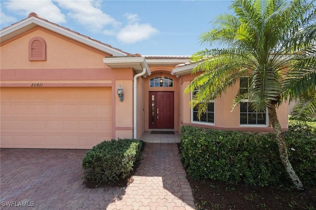 doorway to property with a garage