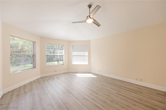 spare room with light wood-type flooring and ceiling fan