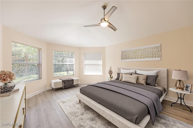 bedroom featuring light hardwood / wood-style floors and ceiling fan