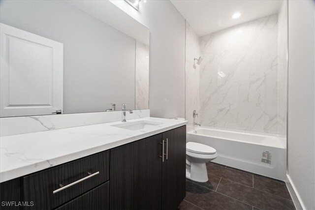 full bathroom featuring toilet, tiled shower / bath combo, vanity, and tile patterned flooring